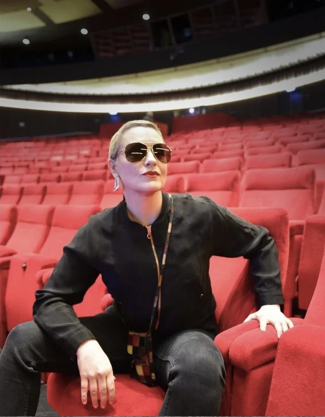 Regina Lund in a theatre auditorium